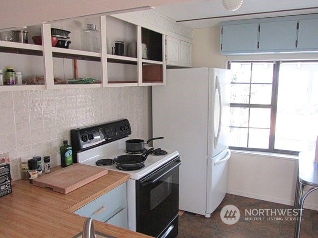 309 North Main Street Riverside, WA 98849 - Photo 8 of 31 a kitchen with stainless steel appliances granite countertop a stove a sink and a refrigerator