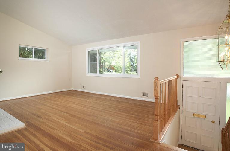 11204 Monticello Avenue Silver Spring, MD 20902 - Photo 11 of 29 a view of an empty room with wooden floor and a window