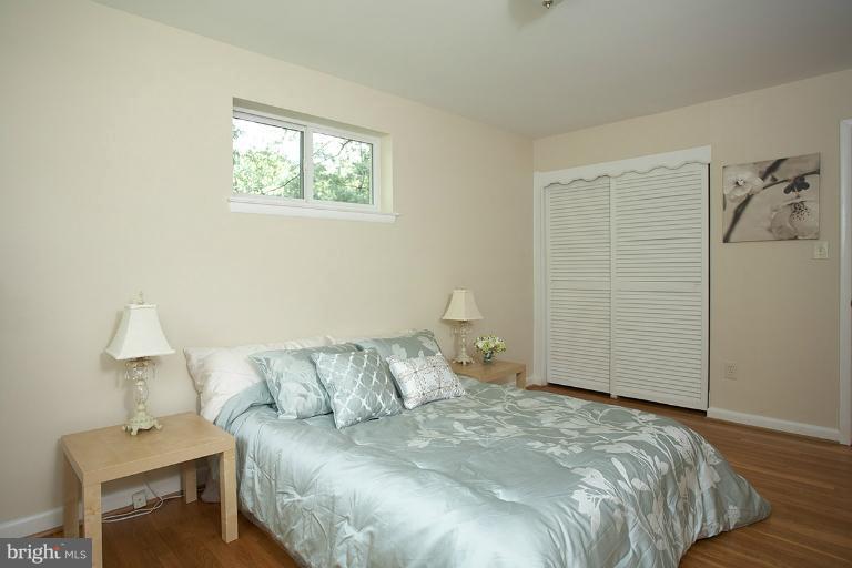 11204 Monticello Avenue Silver Spring, MD 20902 - Photo 14 of 29 a bedroom with a bed and a table