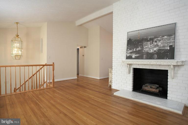 11204 Monticello Avenue Silver Spring, MD 20902 - Photo 22 of 29 a view of an empty room with wooden floor fireplace and a window
