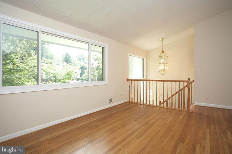 11204 Monticello Avenue Silver Spring, MD 20902 - Photo 26 of 29 a view of an empty room with wooden floor and a window