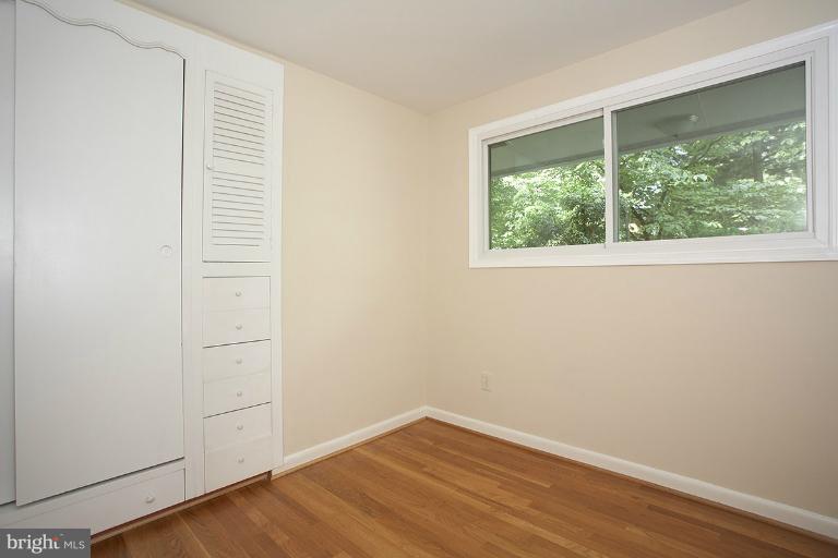 11204 Monticello Avenue Silver Spring, MD 20902 - Photo 8 of 29 an empty room with wooden floor and windows