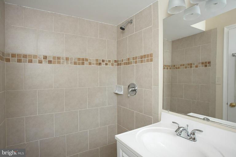 11204 Monticello Avenue Silver Spring, MD 20902 - Photo 9 of 29 a bathroom with a sink shower and a mirror