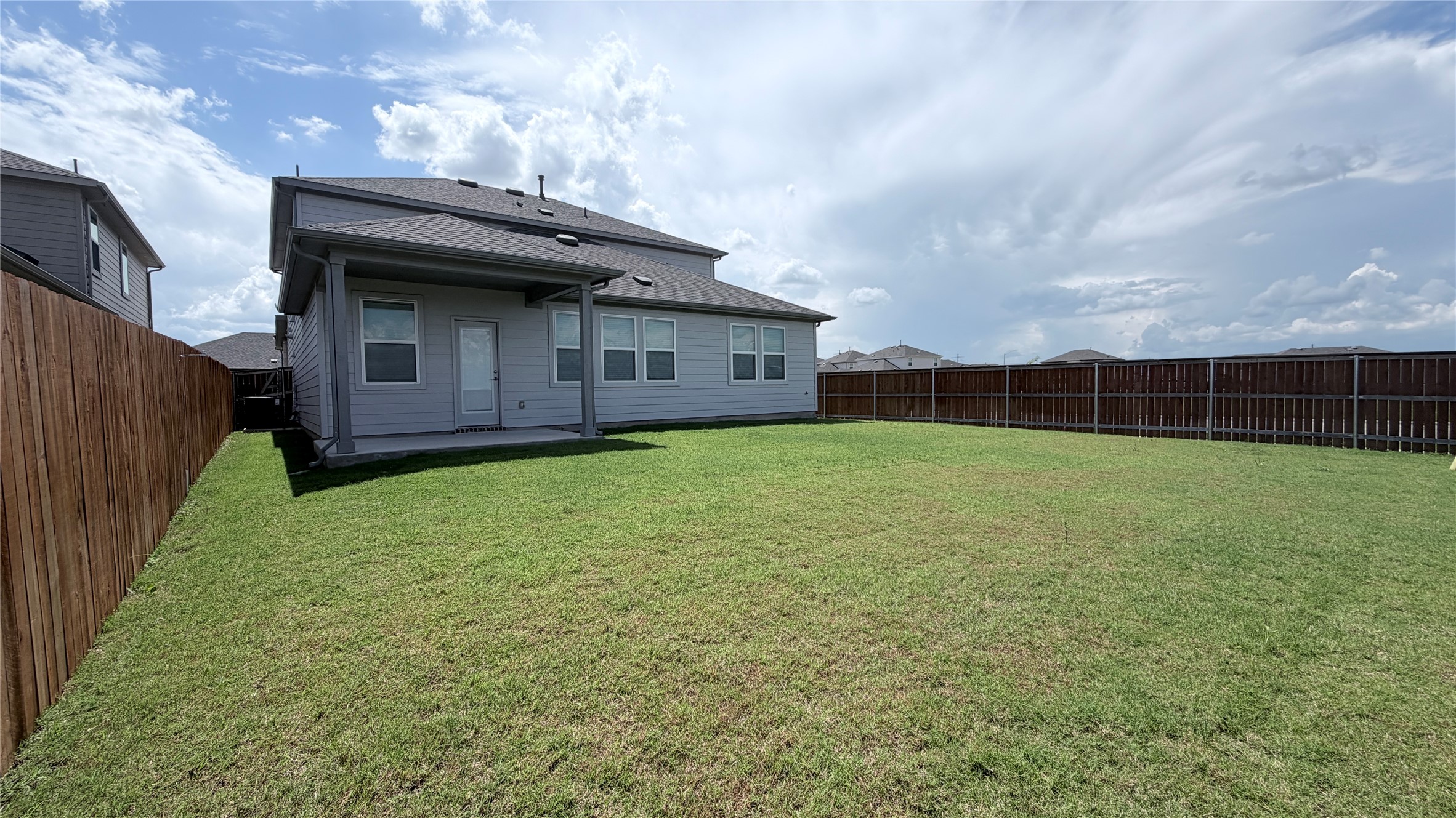 2001 Wynn Road Hutto, TX 78634 - Photo 35 of 39 A spacious, enclosed yard features a covered patio perfect for outdoor enjoyment.