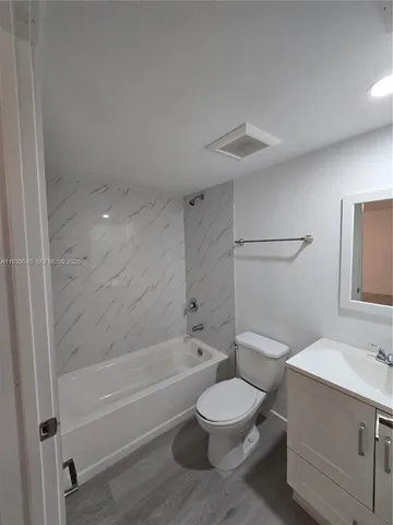 a bathroom with a toilet a sink and bathtub
