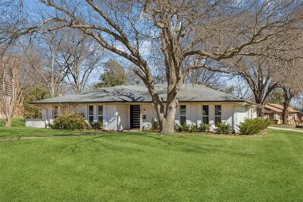 a front view of house with yard and green space