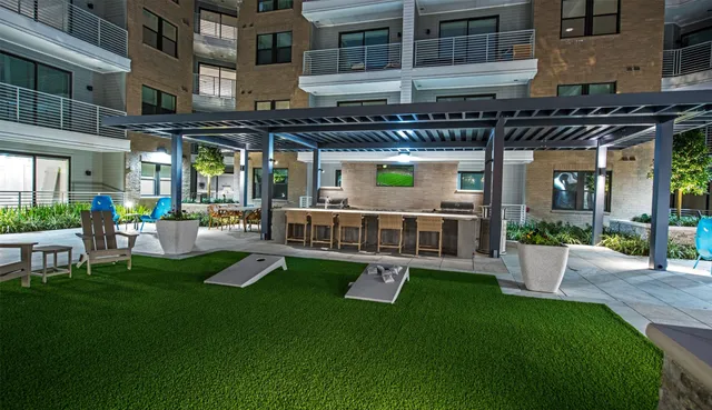 a view of a house with backyard and sitting area