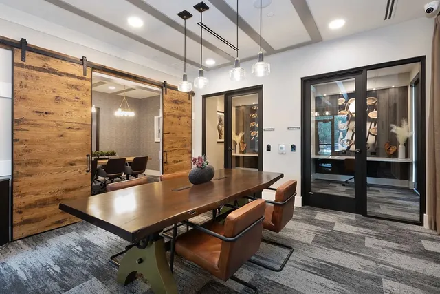 a room with dining table and chairs