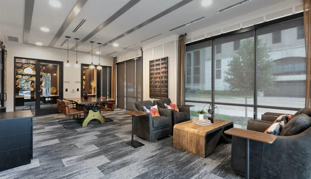 a living room with furniture and large windows