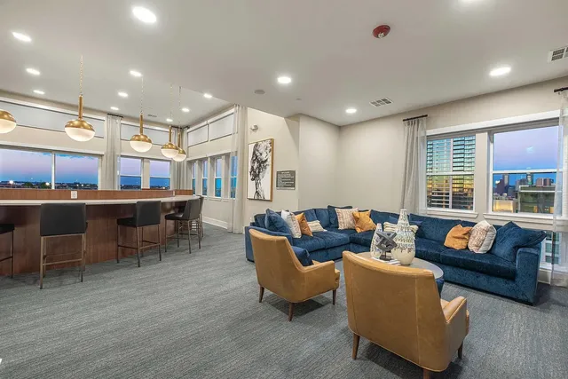 a living room with furniture and a large window