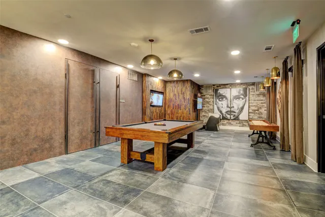 a room with pool table and glass windows