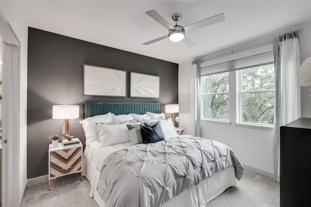 a bedroom with a large bed and a window