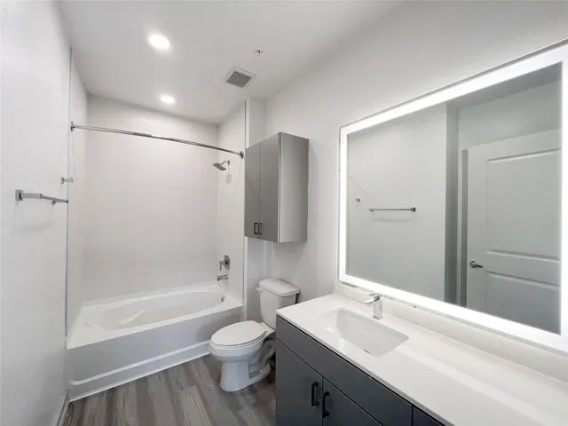 a bathroom with a sink toilet tub and shower