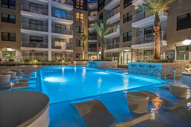a view of a swimming pool with outdoor seating
