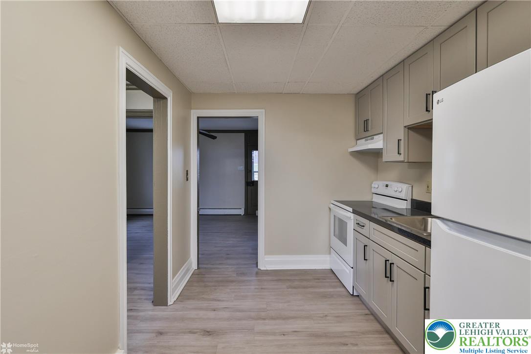 4448 Orefield Road Orefield, PA 18069 - Photo 14 of 20 a kitchen with stainless steel appliances granite countertop a stove and a refrigerator