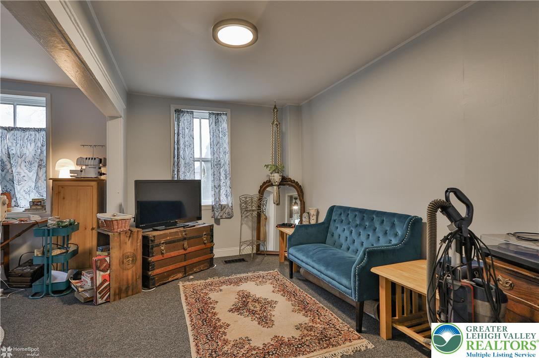 4448 Orefield Road Orefield, PA 18069 - Photo 9 of 20 a living room with furniture a flat screen tv and a fireplace
