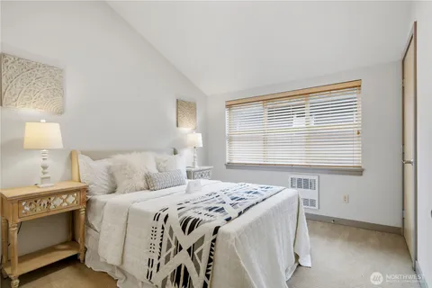 a bed sitting in a bedroom next to a window