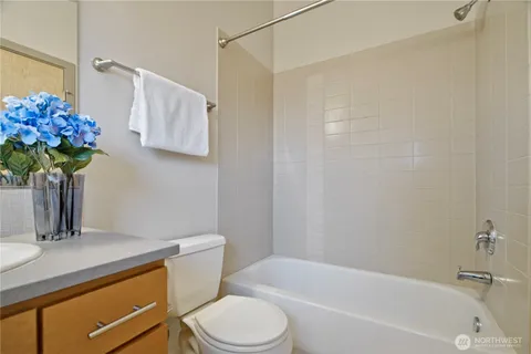 a bathroom with a sink a toilet and bathtub