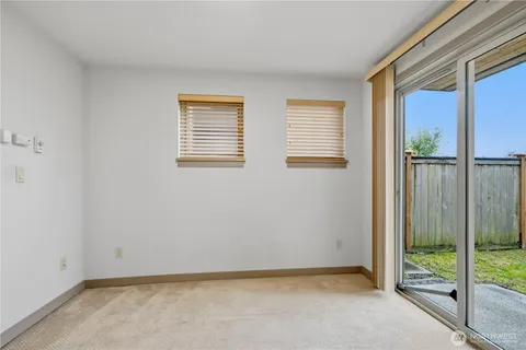 a view of an empty room with glass door