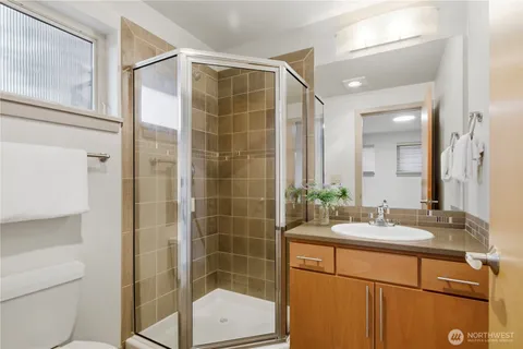 a bathroom with a shower sink and mirror