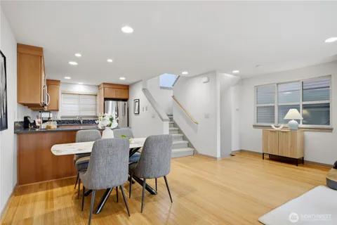 a dining room with furniture and wooden floor