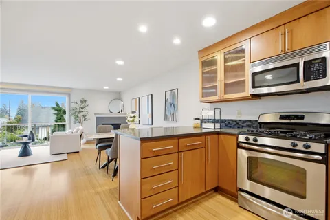 a kitchen with stainless steel appliances granite countertop a stove and cabinets