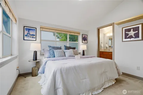 a bedroom with a large bed and a window
