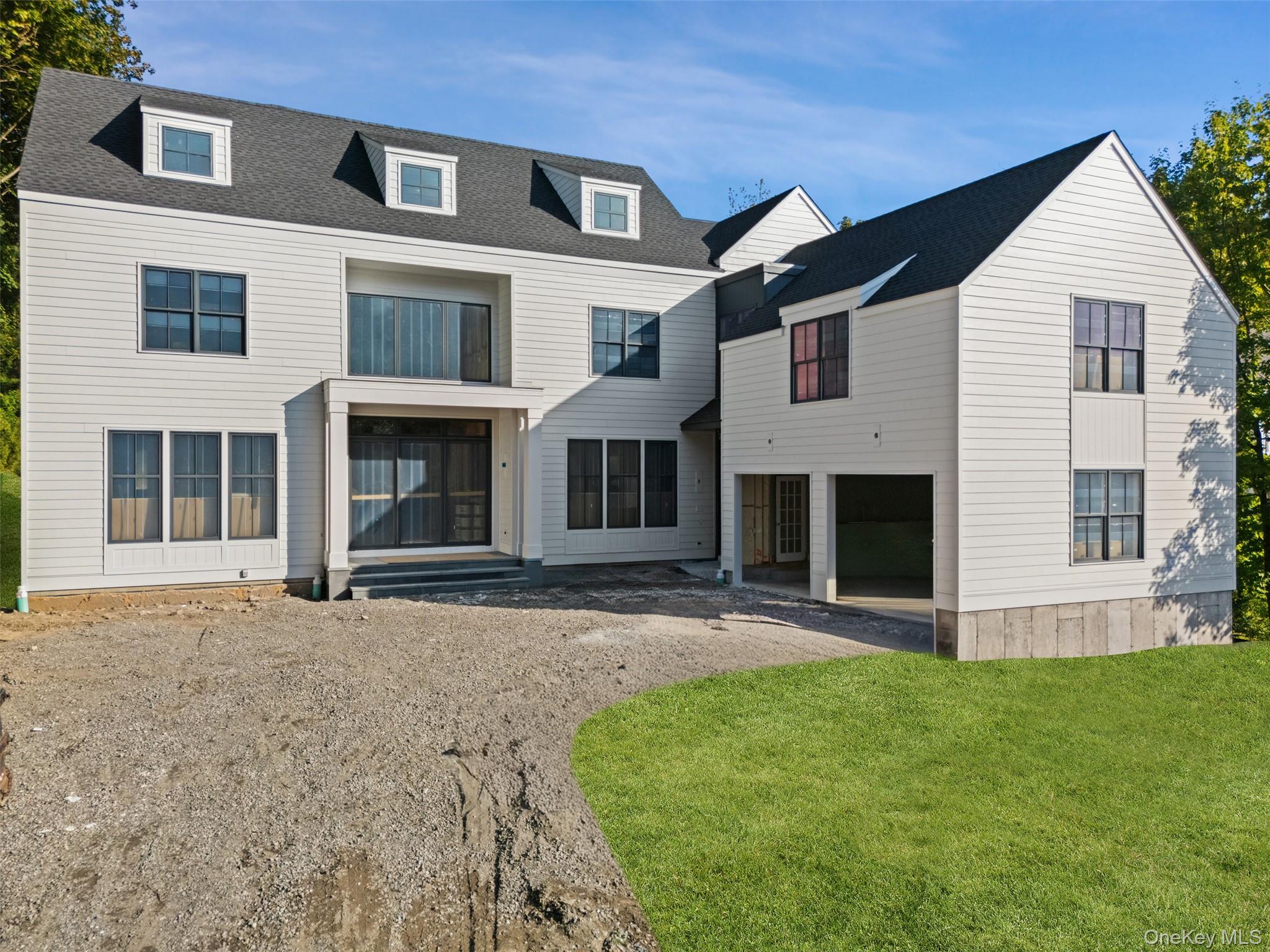 20 Cambridge Road Scarsdale, NY 10583 - Photo 1 of 6 a front view of a house with a garden
