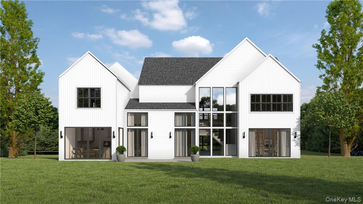 20 Cambridge Road Scarsdale, NY 10583 - Photo 6 of 6 a front view of a house with a garden