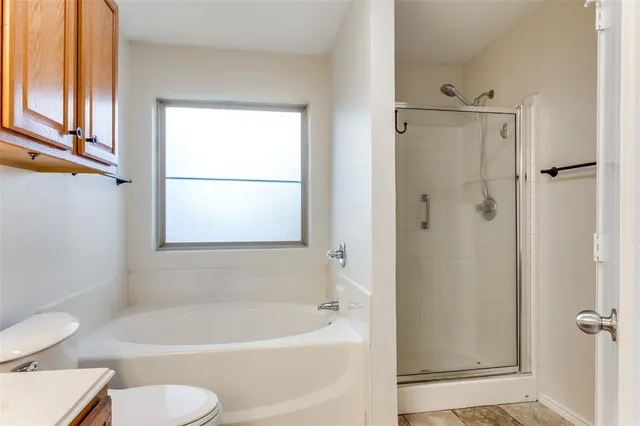 a white bath tub sitting next to a white toilet