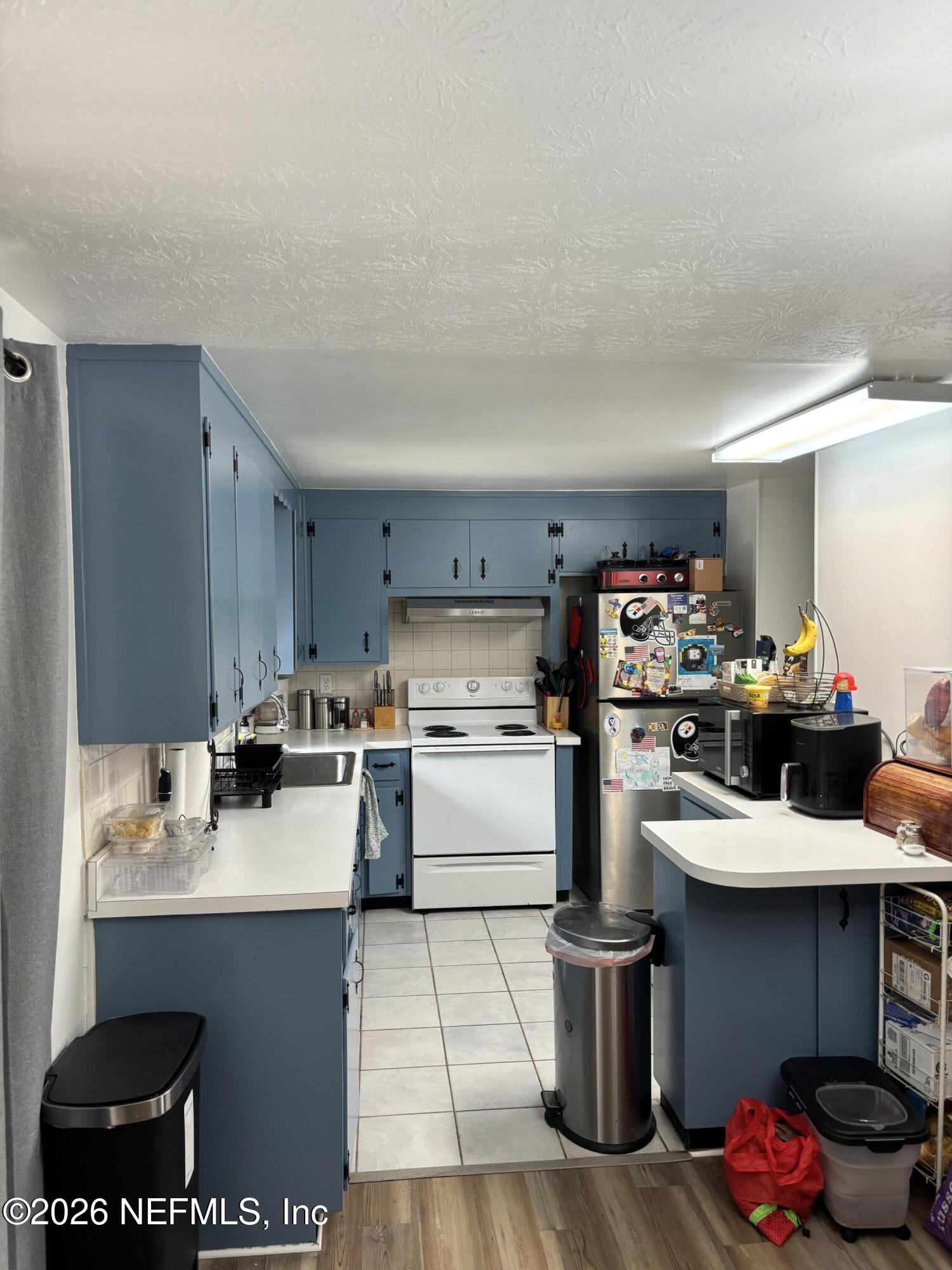 918 Bacall Road Jacksonville, FL 32218 - Photo 3 of 12 a kitchen with a stove and cabinets