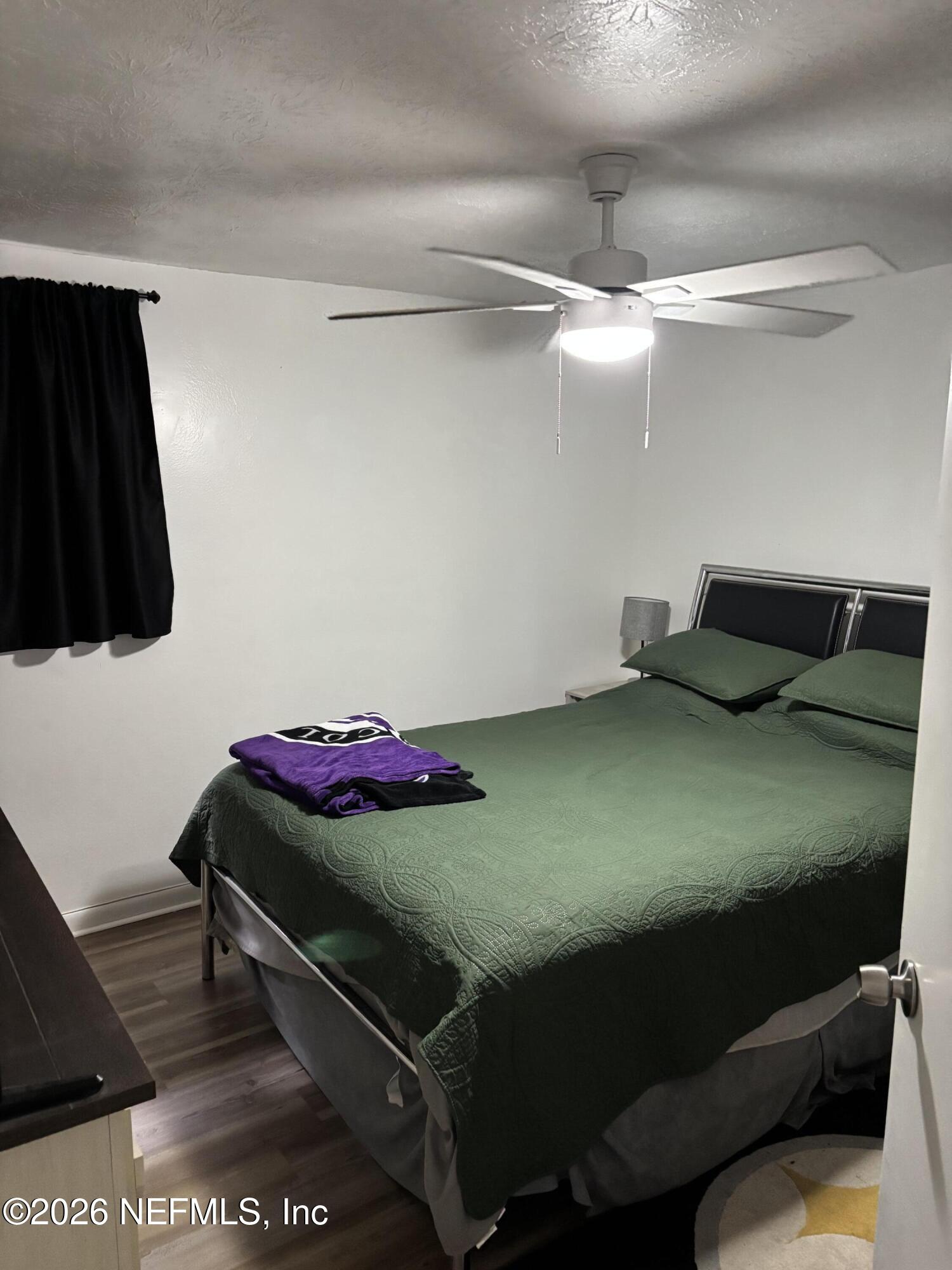918 Bacall Road Jacksonville, FL 32218 - Photo 7 of 12 a bedroom with a bed and a wall painting