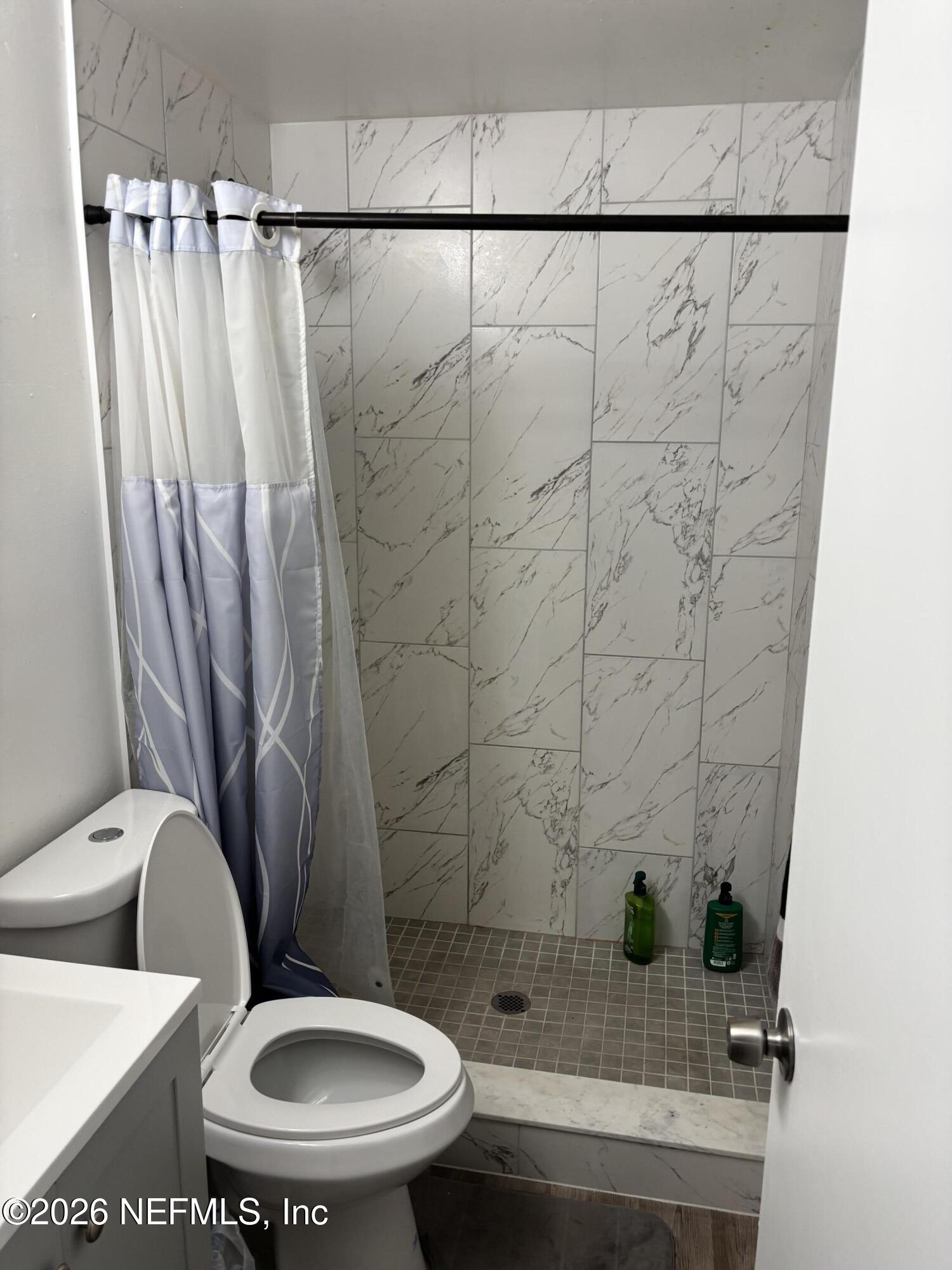 918 Bacall Road Jacksonville, FL 32218 - Photo 8 of 12 a bathroom with a toilet and a shower