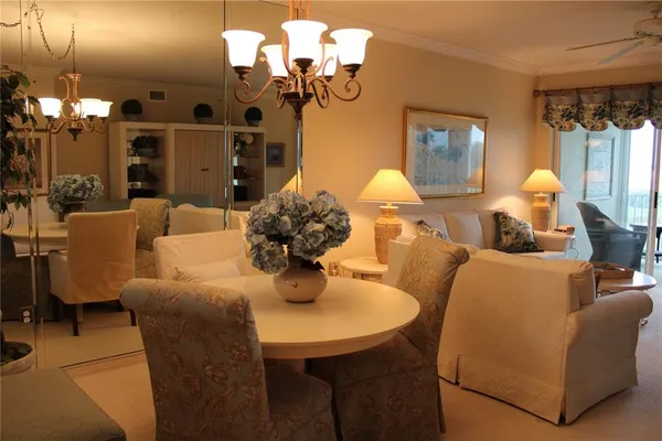 a dining room with furniture and a chandelier