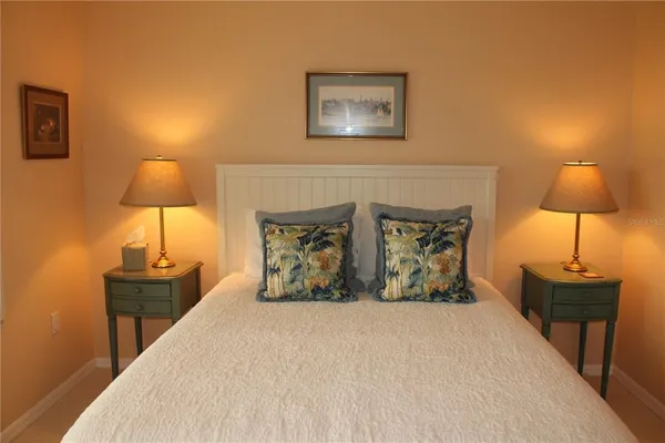 a bedroom with a bed and a lamp