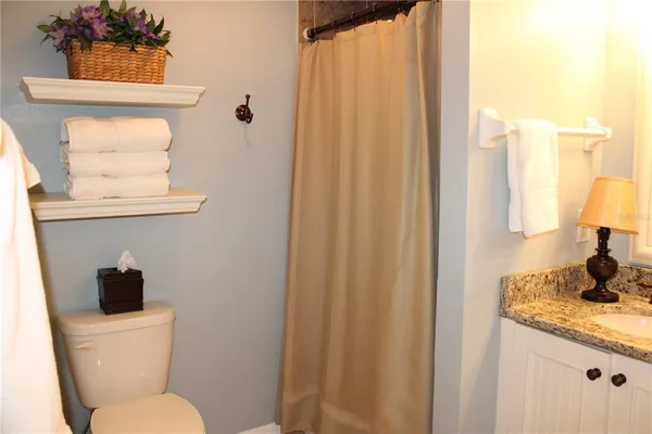 a bathroom with a toilet a sink and a window