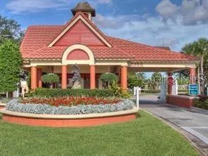 a view of a swimming pool with lawn chairs under an umbrella