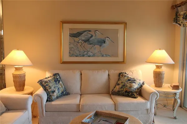 a living room with furniture and a lamp