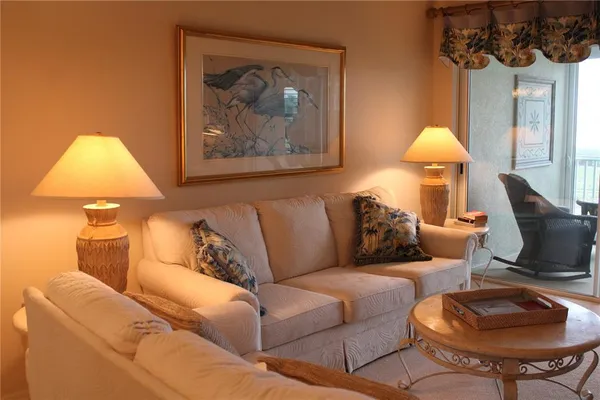 a living room with furniture and a lamp