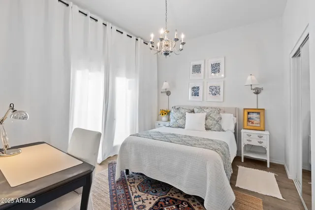 a bedroom with a bed and a chandelier