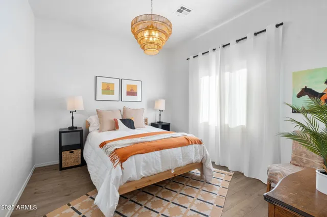 a view of a house with a yard and a large tree