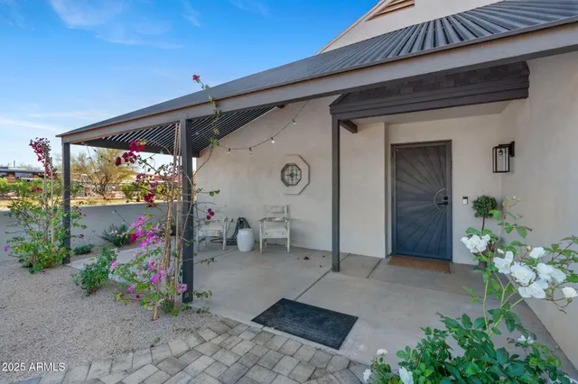a front view of a house with flower pots