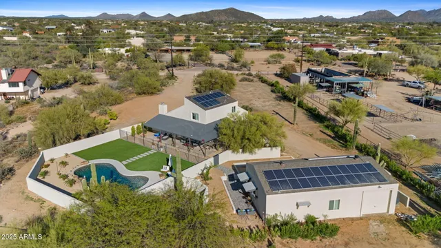 an aerial view of residential houses with outdoor space and river