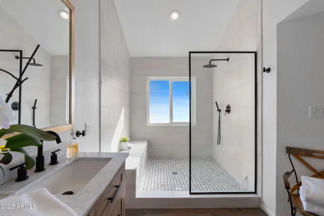 a bathroom with a tub sink and mirror