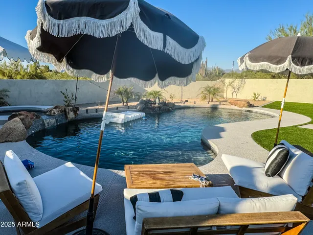 a living room with furniture a rug and a chandelier