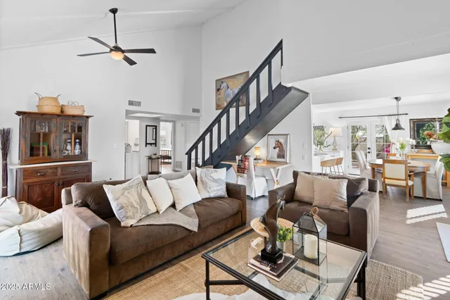 a living room with furniture and wooden floor