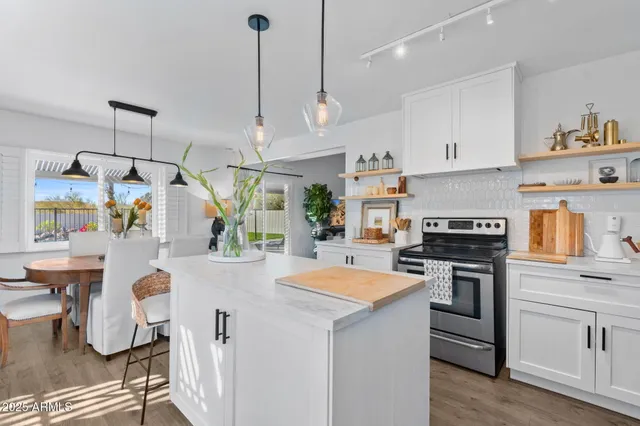 a kitchen that has a lot of cabinets in it and appliances