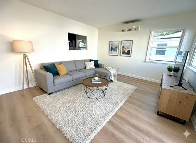 a living room with furniture and a night stand