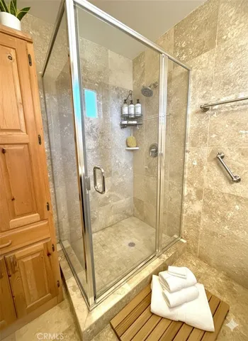 a bathroom with a shower and a sink