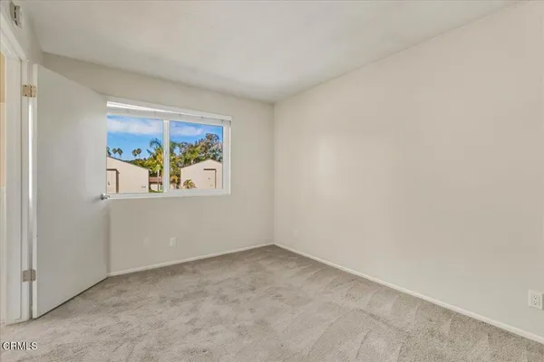 an empty room with windows and wall painting